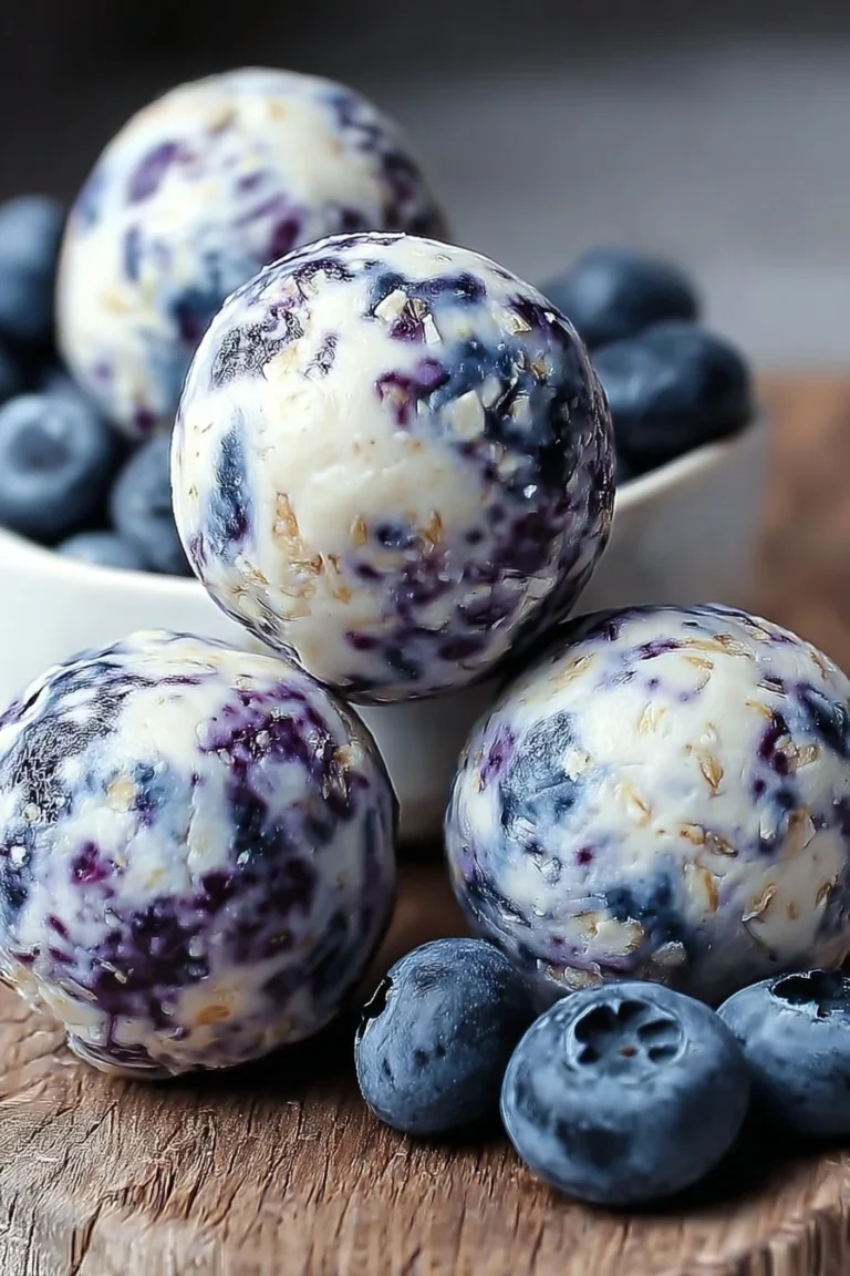 Homemade blueberry cheesecake protein bites on a plate