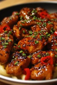 Delicious honey pepper chicken garnished, showcasing its sweet and spicy flavor.