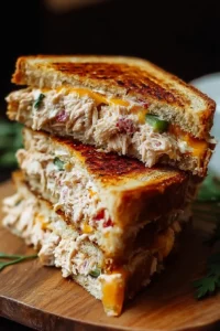 Tuna melt grilled sandwich with melted cheese and tuna filling on toasted bread