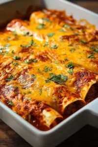 Cheesy 5-Ingredient Beef Enchiladas topped with sauce and cheese