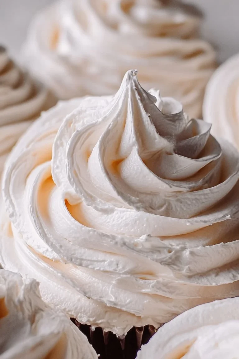 Delicious marshmallow icing spread on a decadent cake.