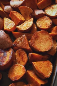 Plate of Roasted Apple Cinnamon Sweet Potatoes garnished with herbs